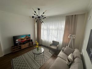 a living room with a couch and a television at Center of city in Beşiktaş 2 plus 1 with 2 Bathroom and 3 Air Conditioner in Istanbul