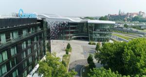 a large glass building with a lot of shoes on it at Q Hotel Plus Kraków in Kraków