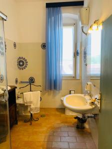 bagno con lavandino, servizi igienici e finestra di Podere Gradisca ad Alberese