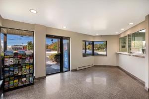 a grocery store aisle with glass doors and windows at RED CARPET INN EDISON in Edison