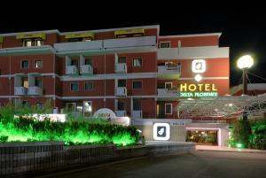 a hotel with a hotel sign in front of a building at Hotel Delta Florence in Calenzano