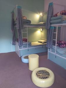a room with two bunk beds and a rug at The Bunker House in Chopta