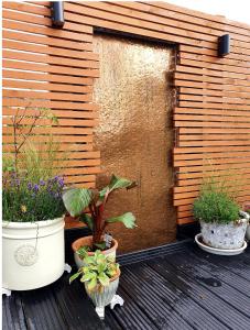 a group of potted plants on a wooden deck at Brecon Burrows in Dowlais