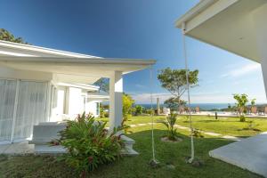 a house with a porch with a swing at Adeluna Luxury Villas in Montezuma