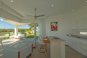 a kitchen with a couch and a table and a counter at Adeluna Luxury Villas in Montezuma