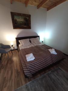 1 dormitorio con 1 cama con 2 toallas en Borostyán Apartmanház en Mórahalom