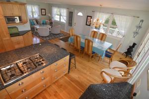 a kitchen and living room with a table and a dining room at Carraig Mor Cottage - Beautiful House, Amazing Garden, Downtown Baileys Harbor in Baileys Harbor