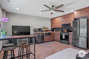 a kitchen with stainless steel appliances and wooden cabinets at Modern Luxurious Stay Bidet Lighted Mirror in Rapid City