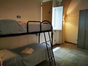 a room with two bunk beds and a window at LA VECCHIA TORRE 1920 in Grottaglie