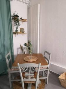 a dining room table and chairs with a vase on it at BNB Le BOHEMIEN Hyper Centre 5' Train Station in Orléans