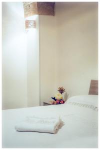 a white bed with a white blanket on it at LA VECCHIA TORRE 1920 in Grottaglie +10 photos