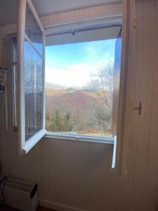 a window in a room with a view of a mountain at Appartement Col de Latrape in Aulus-les-Bains