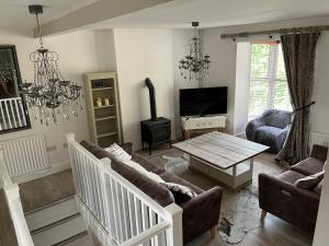 a living room with a couch and a table at Matlock Maisonette in Matlock