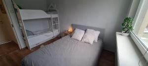 a small bedroom with a bed and a bunk bed at Viscosa Holiday Apartment in Kõrgessaare