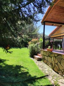 a yard with a stone wall and a house at La Finca de Gredos in Hoyos del Espino +16 photos