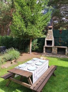 a table with plates and glasses on it in a yard at La Finca de Gredos in Hoyos del Espino