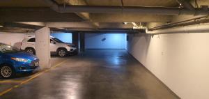 a parking garage with two cars parked in it at VM 1254 - Departamento APART - con Cochera in Rosario