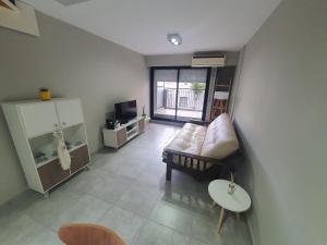 a living room with a couch and a table at VM 1254 - Departamento APART - con Cochera in Rosario