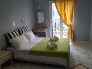 a bedroom with a bed with two towels on it at Katerina Lefkada in Vasiliki