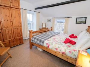 a bedroom with a bed with red towels on it at Arwel in Capel Garmon