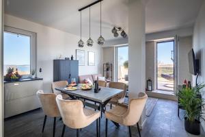 a kitchen and dining room with a table and chairs at Balatonic Panoráma in Zamárdi