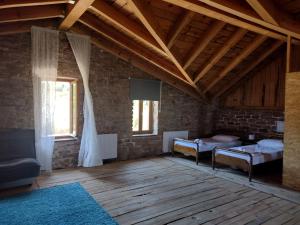 a room with two beds and a brick wall at Raphale in Preveza