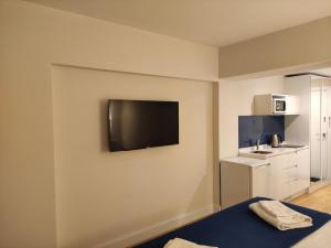 a room with a flat screen tv on the wall at ORBI CITY in Batumi