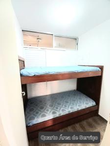 a small room with a bunk bed in it at Apartamento Praia de Pitangueiras Pé na Areia Vista para o Mar in Guarujá
