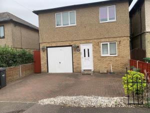 a brick house with white doors and a brick driveway at Huntingdon walk to town centre, cosy, Free parking in Huntingdon