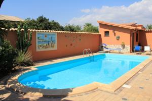 a swimming pool in a yard with a house at Villa Salvatore in San Leone