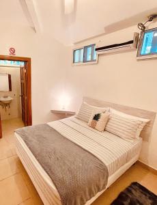 a bedroom with a large bed and a window at Pineapple House in Bocas Town