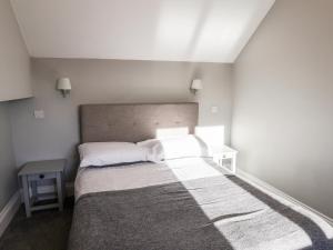 a small bedroom with a bed and a table at The Pheasantry in Scarborough