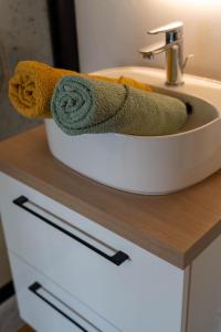 a towel sitting on top of a bathroom sink at Casa Ragazzi - Refait à neuf - Calme - Parking in Lempdes