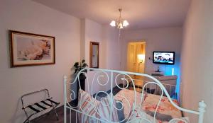 a bedroom with a bed with a wrought iron railing at Privatzimmer in Siebenlehn