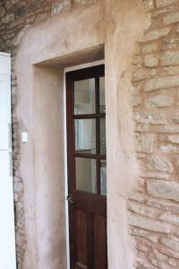 a door in a stone building with a window at Pump Cottage - Cosy Herefordshire Cottage in Hereford