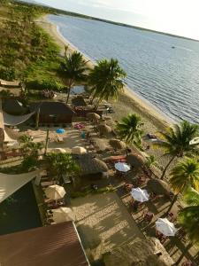 an aerial view of a beach with palm trees and umbrellas at Joe's Shack - A cosy oasis in Nadi close to the beach, supermarkets, restaurants, Denarau Island and the Marina. in Nadi