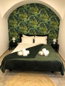 a bedroom with a large bed with towels on it at NatureHouse in Campo Maior