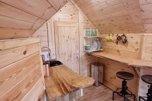 a kitchen with a counter in a wooden cabin at Woodland Cabin with Hot tub & log burner in Barmouth