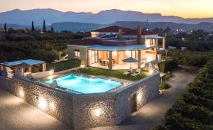 an aerial view of a house with a swimming pool at Cretan Vineyard Hill Villa 2 in Áno Kalésia