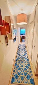 a hallway with a blue and white flooring in a house at CANNES Front de Mer - Appartement 3 STAR in Cannes