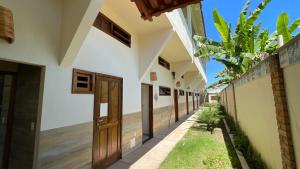 an empty corridor of a house with wooden doors at Canoa Azul in Garapuá