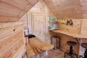 a kitchen with a counter in a wooden cabin at Tree Top Cabin with log burner & private hot tub in Barmouth