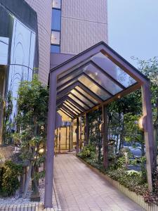 a covered walkway in front of a building at Inuyama City Hotel in Inuyama