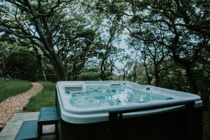 a hot tub sitting in the middle of a yard at Snowdonia Mawddach Cabin + hot tub in Barmouth