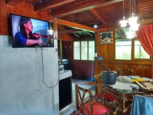 a living room with a tv on a refrigerator at Casa en el rincon familiar en Mindo in Mindo
