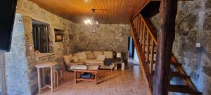 a living room with a couch and a staircase at Casa de Férias V6 com piscina in Ponte de Lima