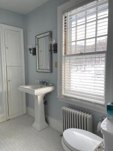 a bathroom with a sink and a toilet and a window at Willow 