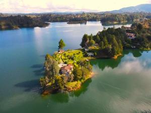 an island in the middle of a large body of water at El Trebol in Guatapé