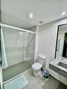 a bathroom with a shower and a toilet and a sink at Apts 501 e 705 Diamond Flats in São Lourenço