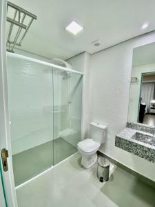 a bathroom with a shower and a toilet and a sink at Apts 501 e 705 Diamond Flats in São Lourenço